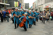 La banda Europa process through the streets of newcastle acompanied by a group of locally recruited snare drummers